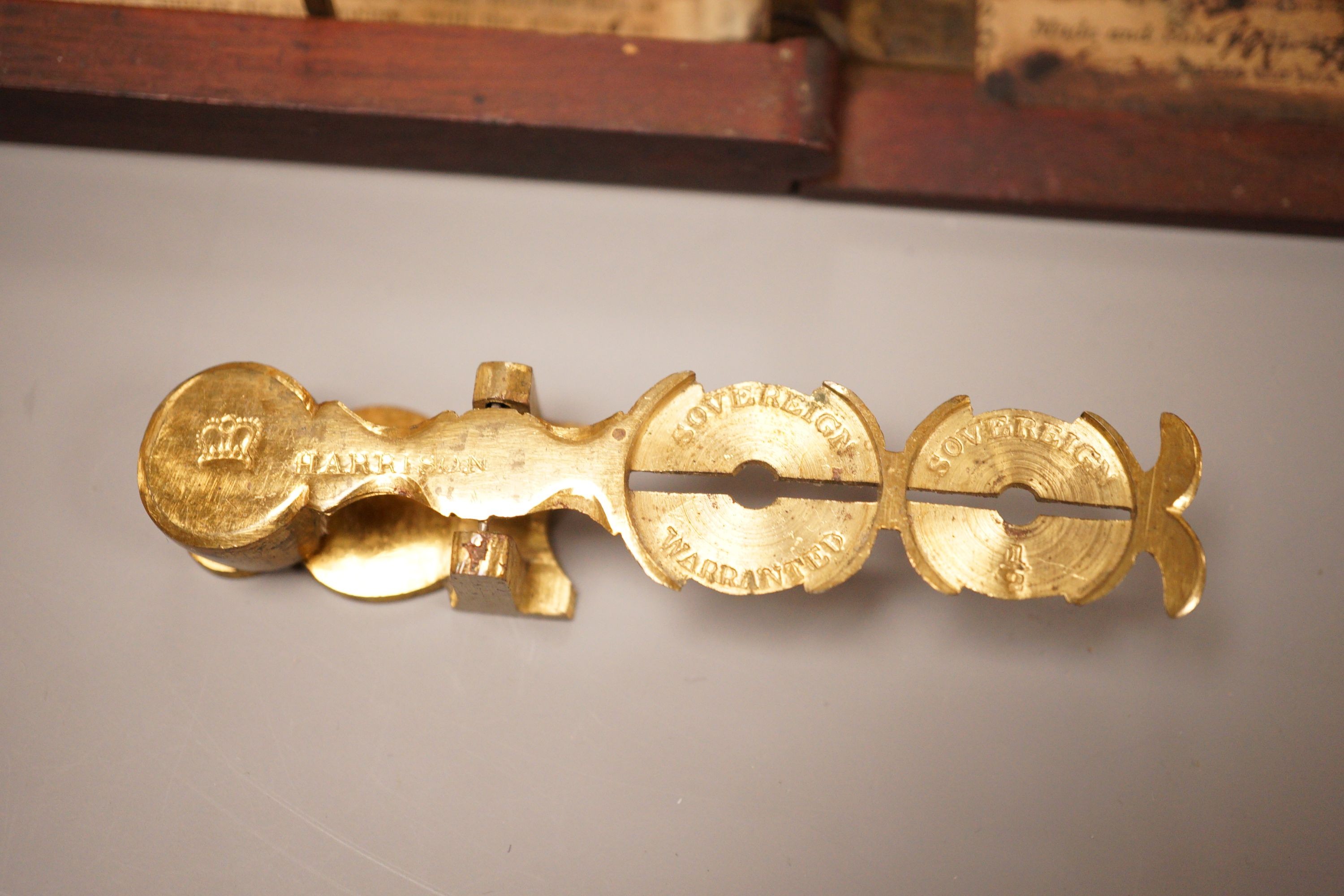 Two sets of gold / coin scales, together with a 1/2 pistol and 1 Guinea